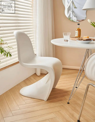 White molded plastic dining chair with sleek modern curves from aimee dining collection