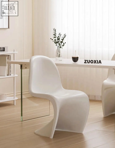 White sleek plastic dining chair with modern sculpted design perfect for aimee dining setups