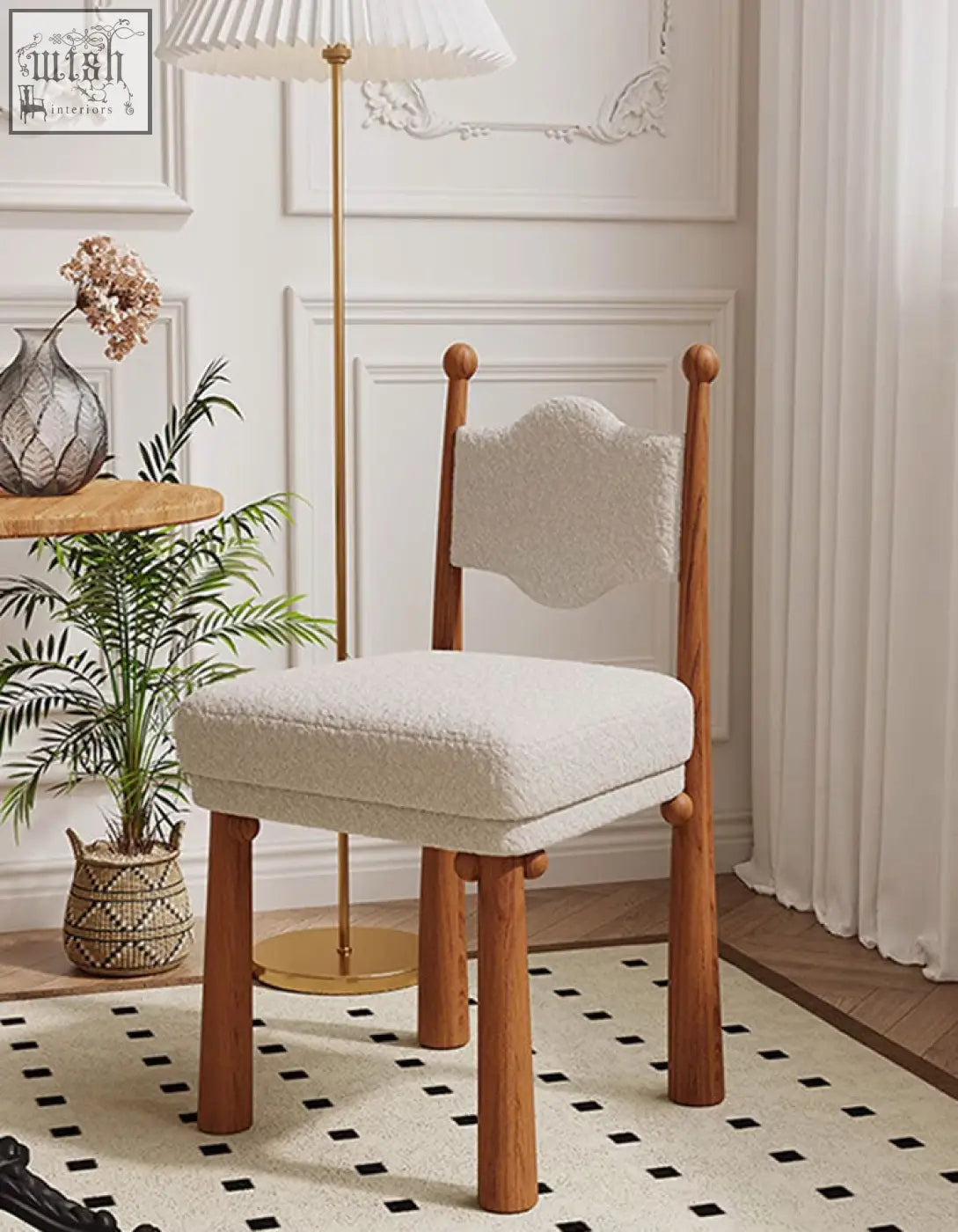 A cozy off-white cashmere ainsley dining chair with a textured cloud-shaped backrest and wooden legs