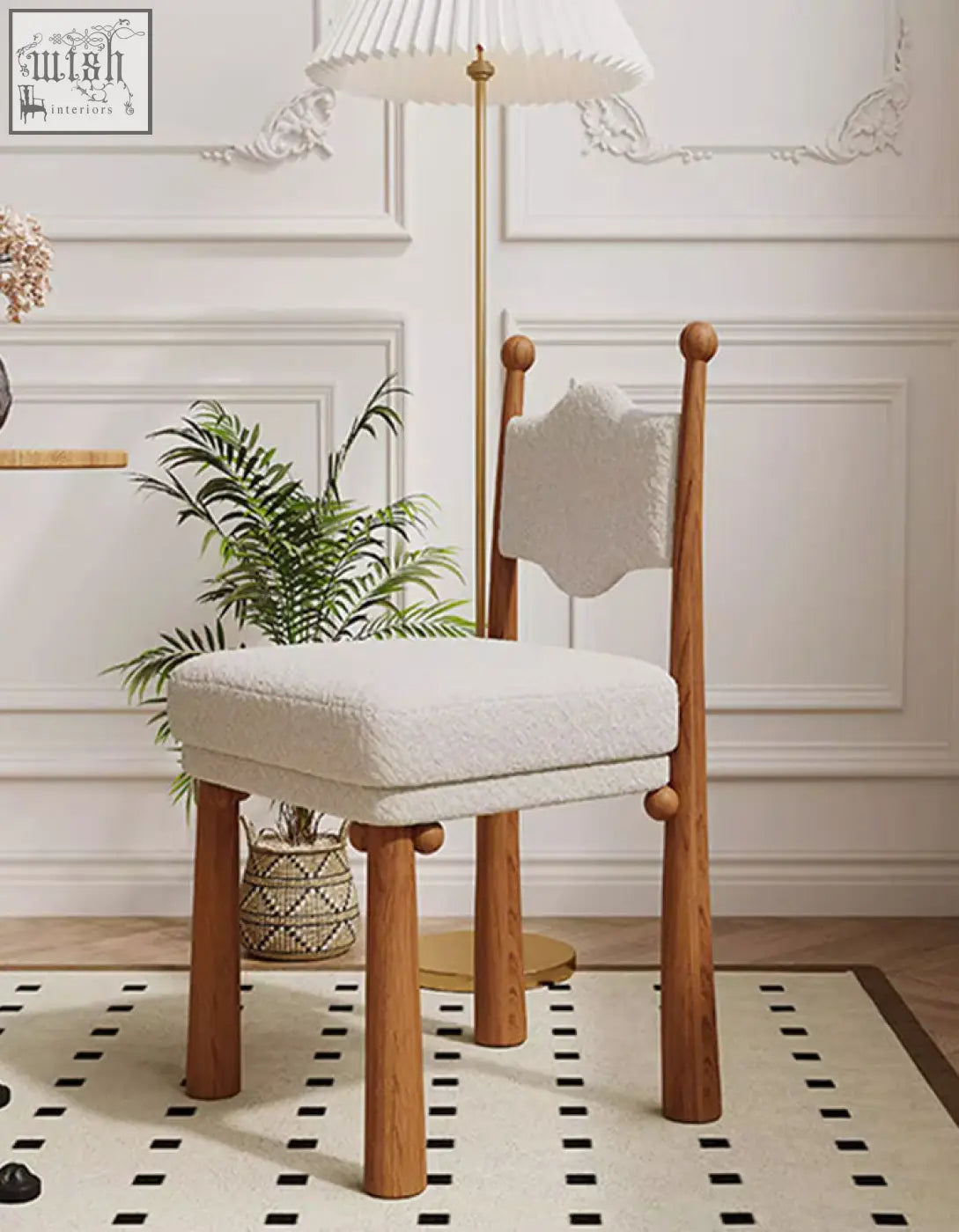 A cozy off-white cashmere ainsley dining chair with wooden legs and a cloud-shaped backrest for dining use