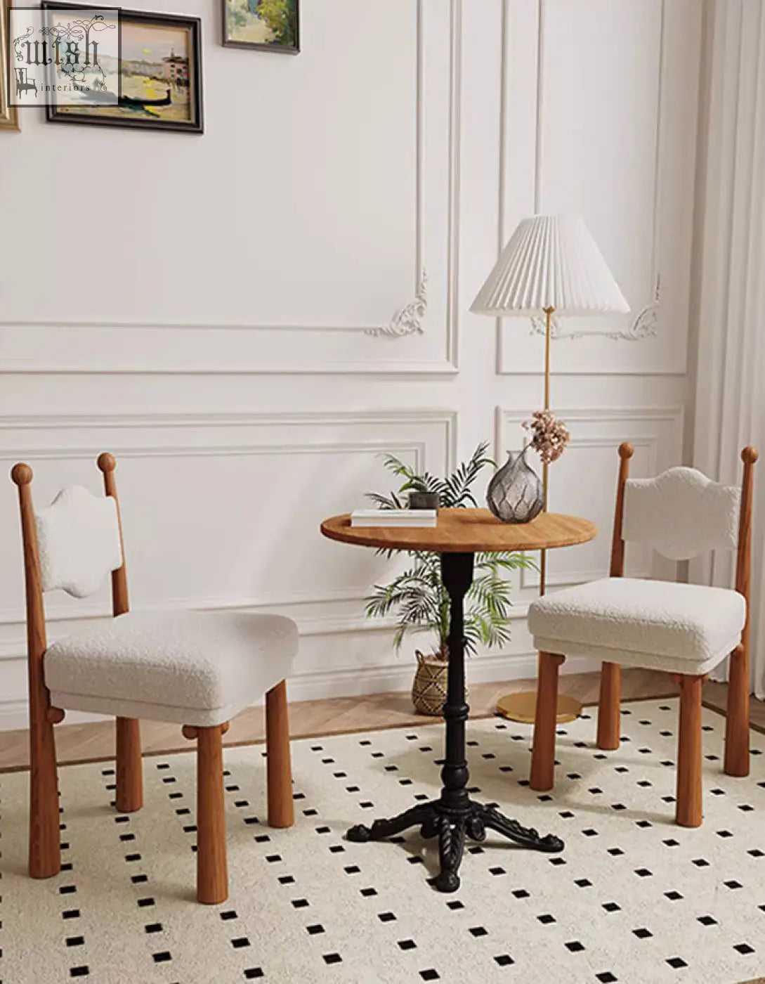 Wooden table with black metal base and round top paired with ainsley dining chair in cashmere fabric