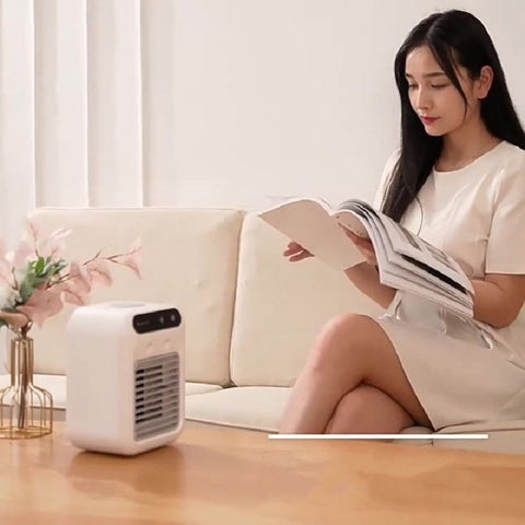 White compact portable air conditioner with black vent grille featuring atomization technology for room and office use