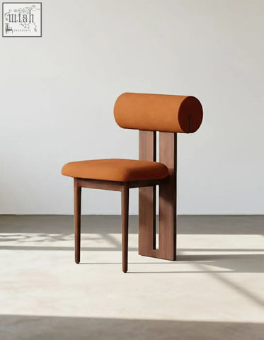 A modern airelle dining chair with cylindrical orange upholstery and black brown wood legs perfect as a dining chair