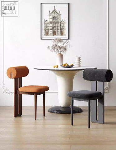Modern airelle dining chair with cylindrical orange and dark gray fabric backrests and sleek wooden legs in black and brown