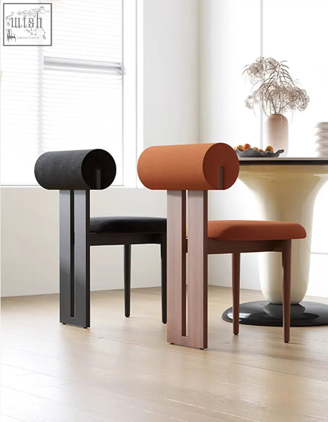 Modern minimalist airelle dining chairs with black and terracotta fabric cylindrical backrests and sleek metal frames