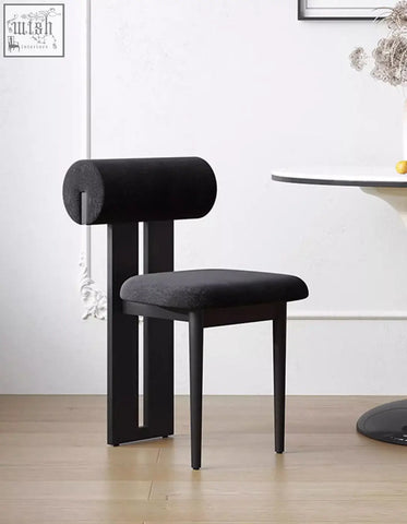 Black airelle dining chair with sleek minimalist frame and cylindrical upholstered backrest perfect for dining