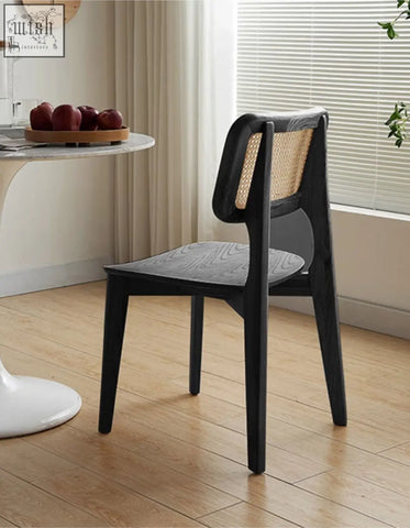 Black wooden aislin rattan dining chair with woven cane backrest and dark gray wood seat for dining use