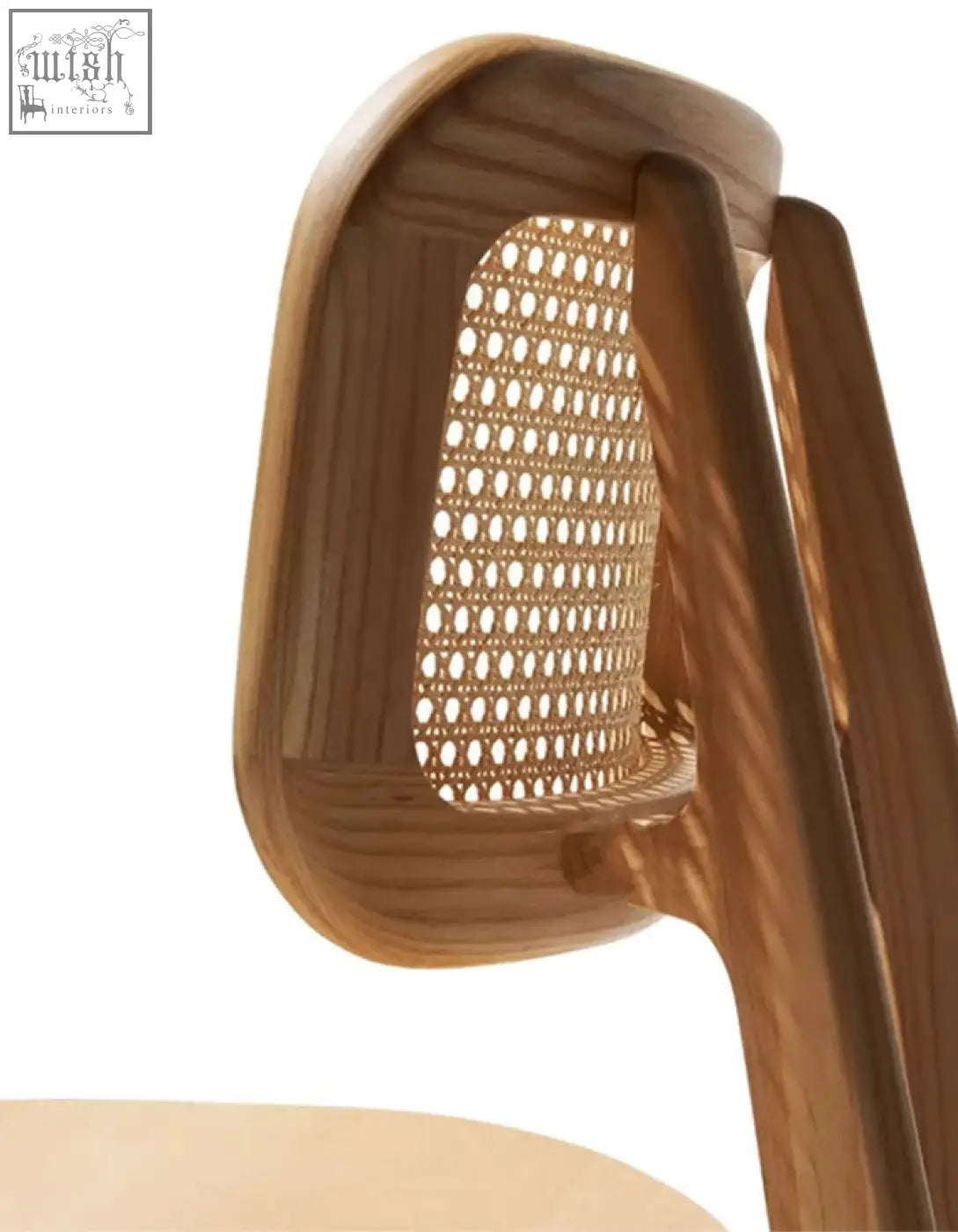 A light brown wooden aislin rattan dining chair with a woven cane backrest and curved frame perfect for dining