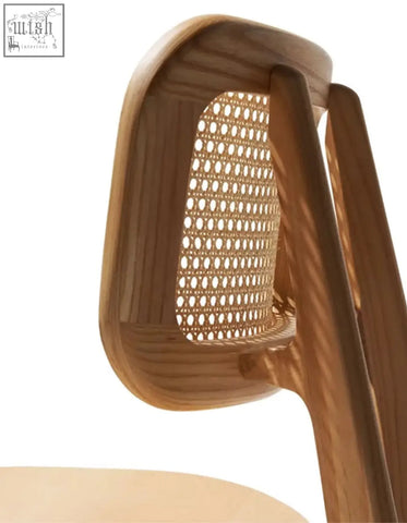 A light brown wooden aislin rattan dining chair with a woven cane backrest and curved frame perfect for dining