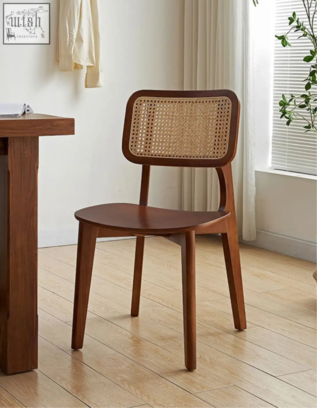 Aislin rattan dining chair with a sleek wooden frame and woven cane backrest in smooth dark brown finish dining chair