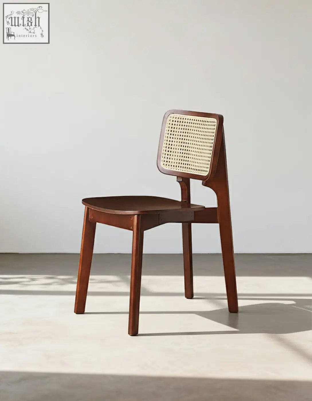 Aislin rattan dining chair with a sleek wooden frame, dark brown finish, and woven cane backrest perfect for dining chair use