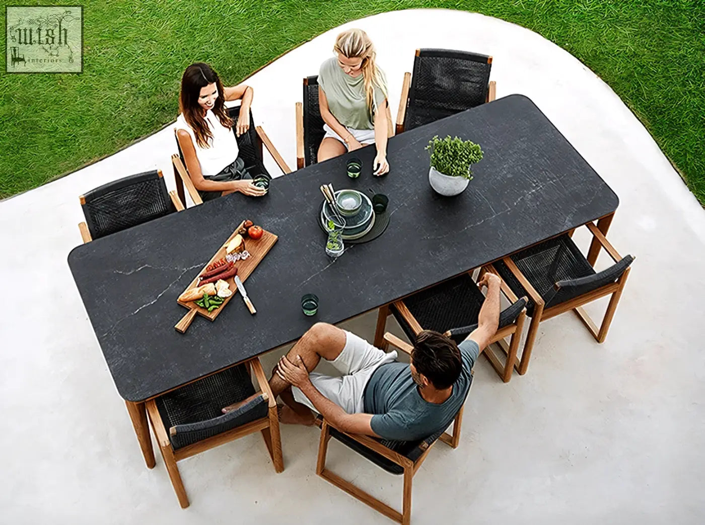 Aisulu 6 seater outdoor dining set with black marble top table and woven black chairs for outdoor dining