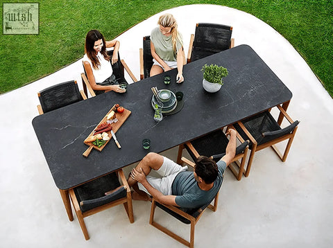 Aisulu 6 seater outdoor dining set with black marble top table and woven black chairs for outdoor dining