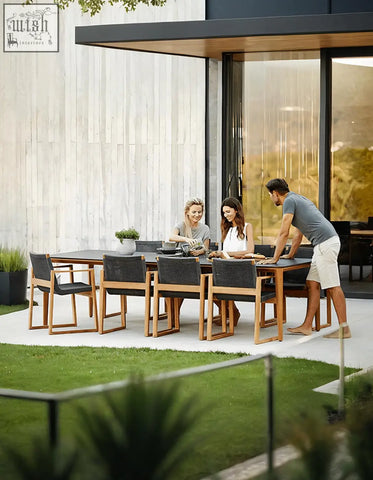 Aisulu 6 seater outdoor dining set with sleek black table wooden legs and dark woven fabric seats perfect for outdoor dining
