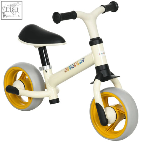 Cream-colored anyplay balance bike with adjustable seat and yellow-rimmed eva wheels for kids training