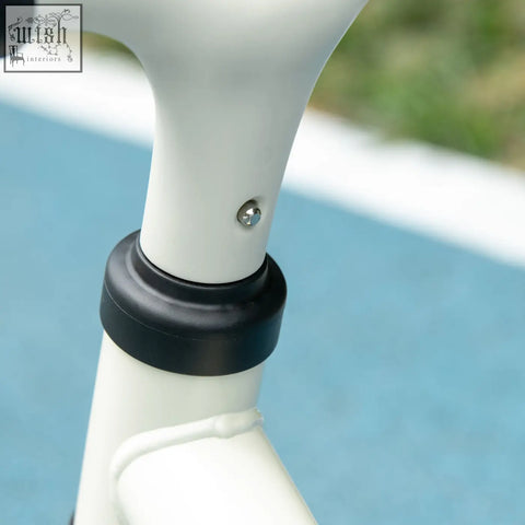 White bicycle handlebar stem with black clamp and silver screw on orange aiyaplay balance bike with eva wheels and adjustable seat
