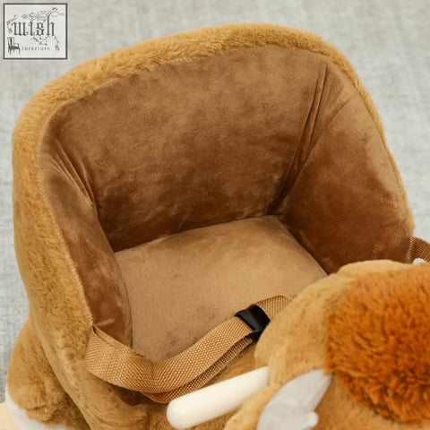A plush tan rocking horse with a soft fuzzy exterior and safety belt featuring a charming cow design by aiyaplay