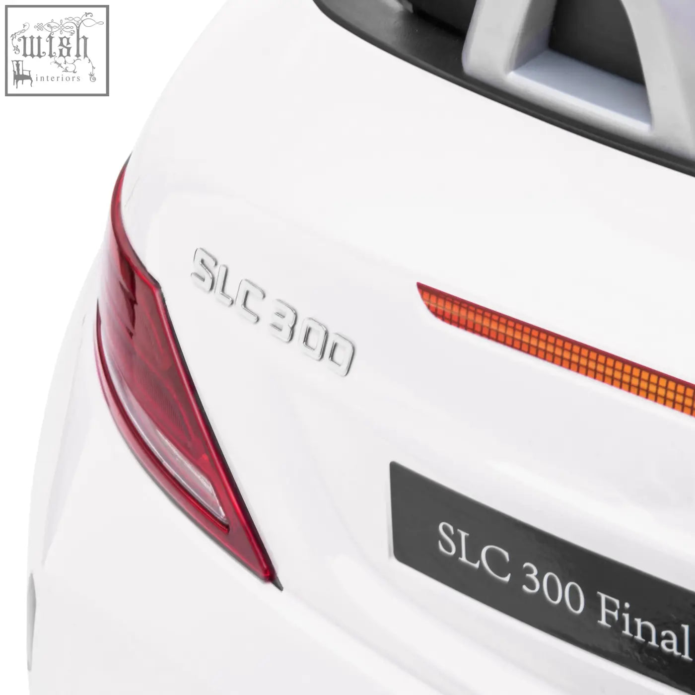 Back of white aiyaplay benz slc 300 electric ride showing slc 300 final edition badge with silver lettering and remote control