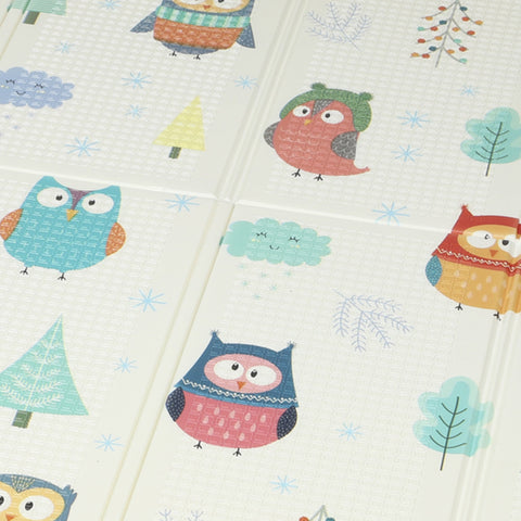 A soft cream-colored foldable baby play mat 200l x 150w cm with owl and car track patterns for kids crawling
