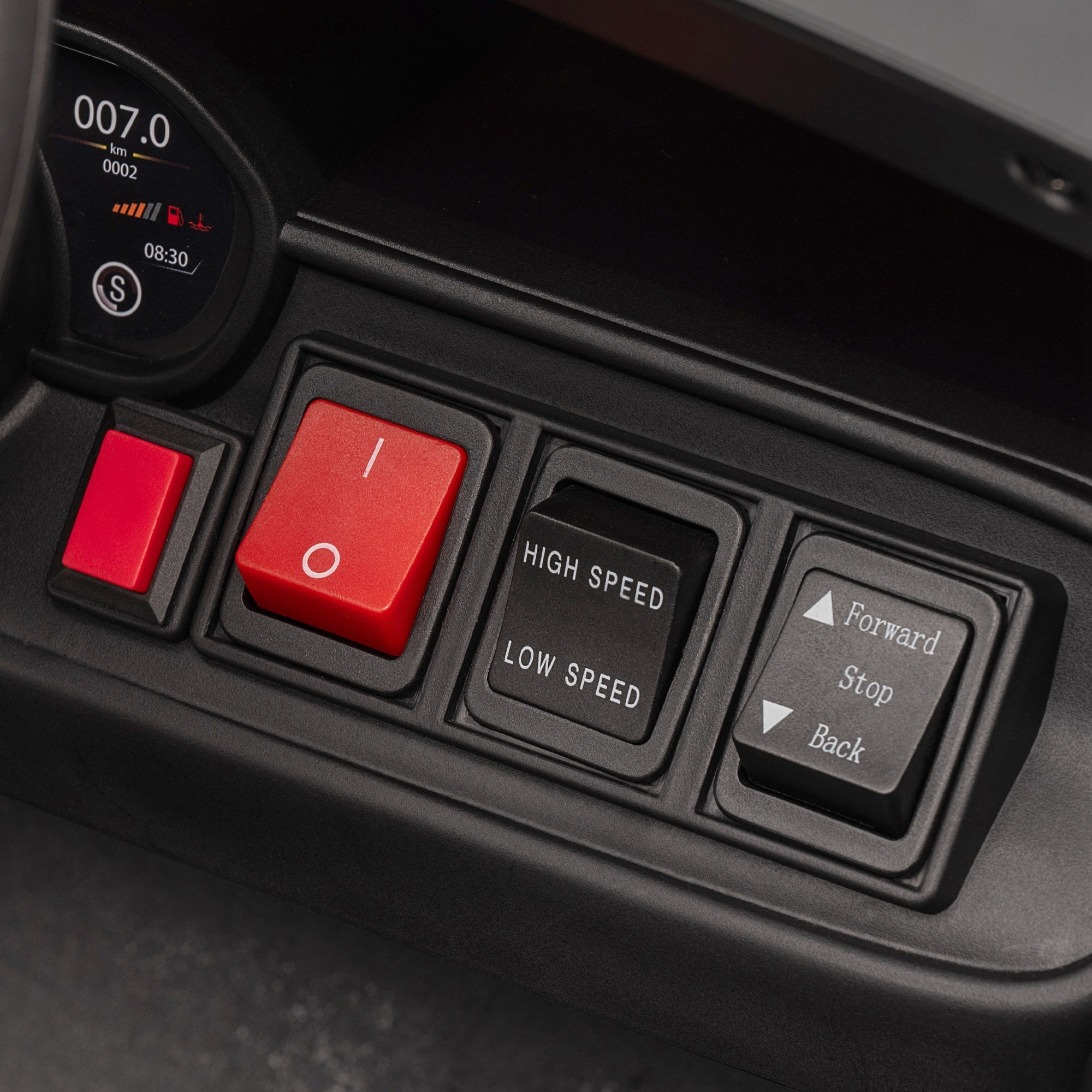 Black plastic control panel with red and black buttons on aiyaplay kids police car remote control for easy driving