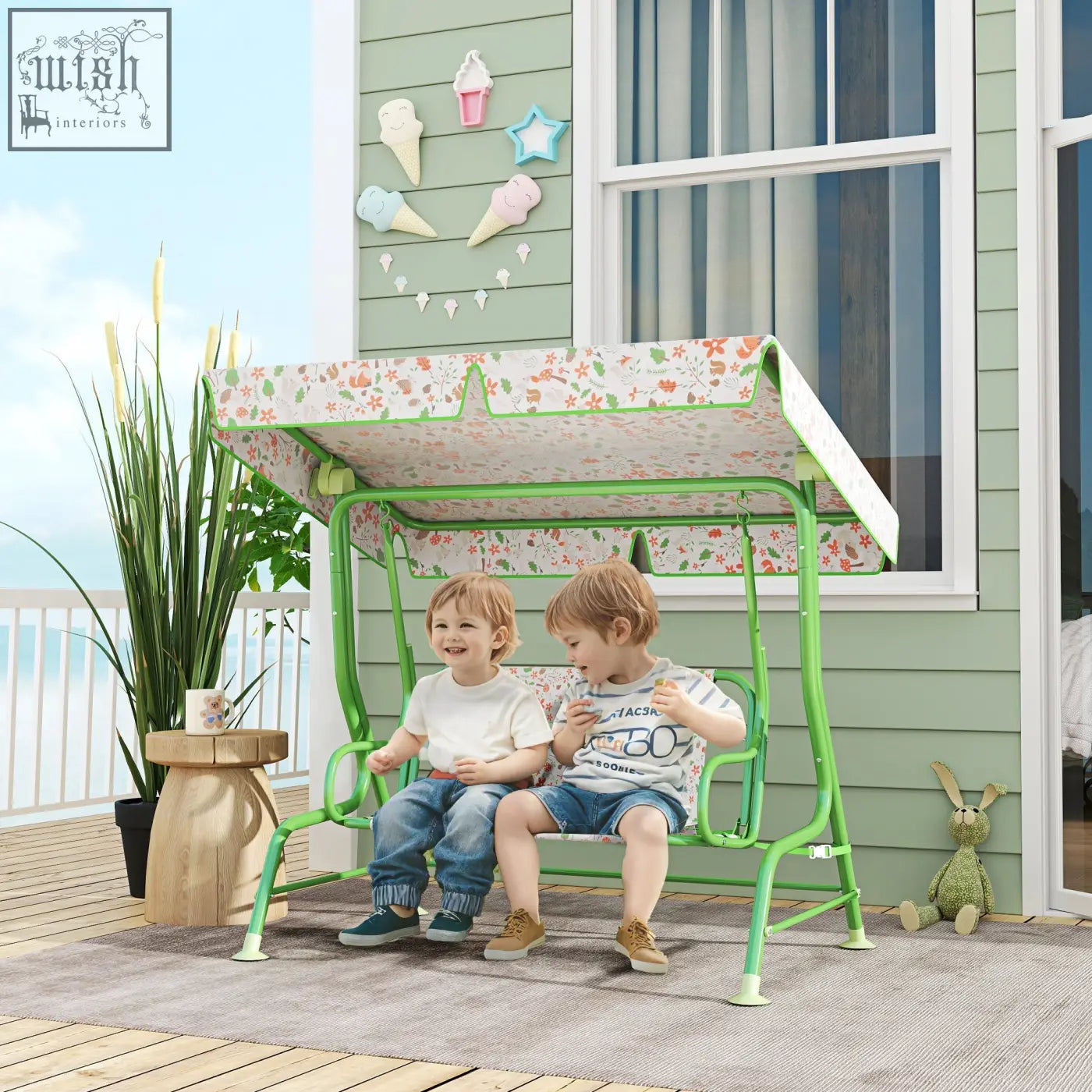 Green metal kids garden swing bench with adjustable floral canopy and non-skid feet for patio or porch use