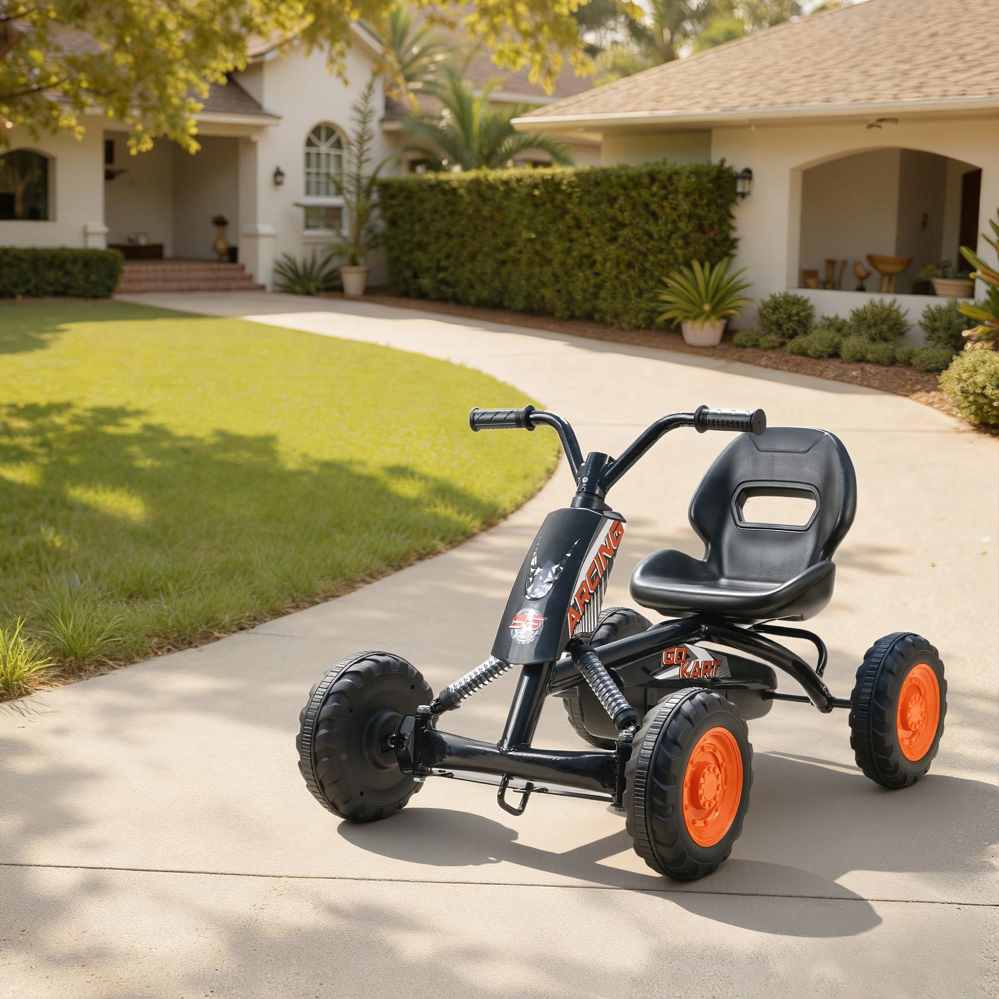 Aiyaplay kids pedal go kart in black and orange with a steel frame and low-to-the-ground design for ages 2-5 years