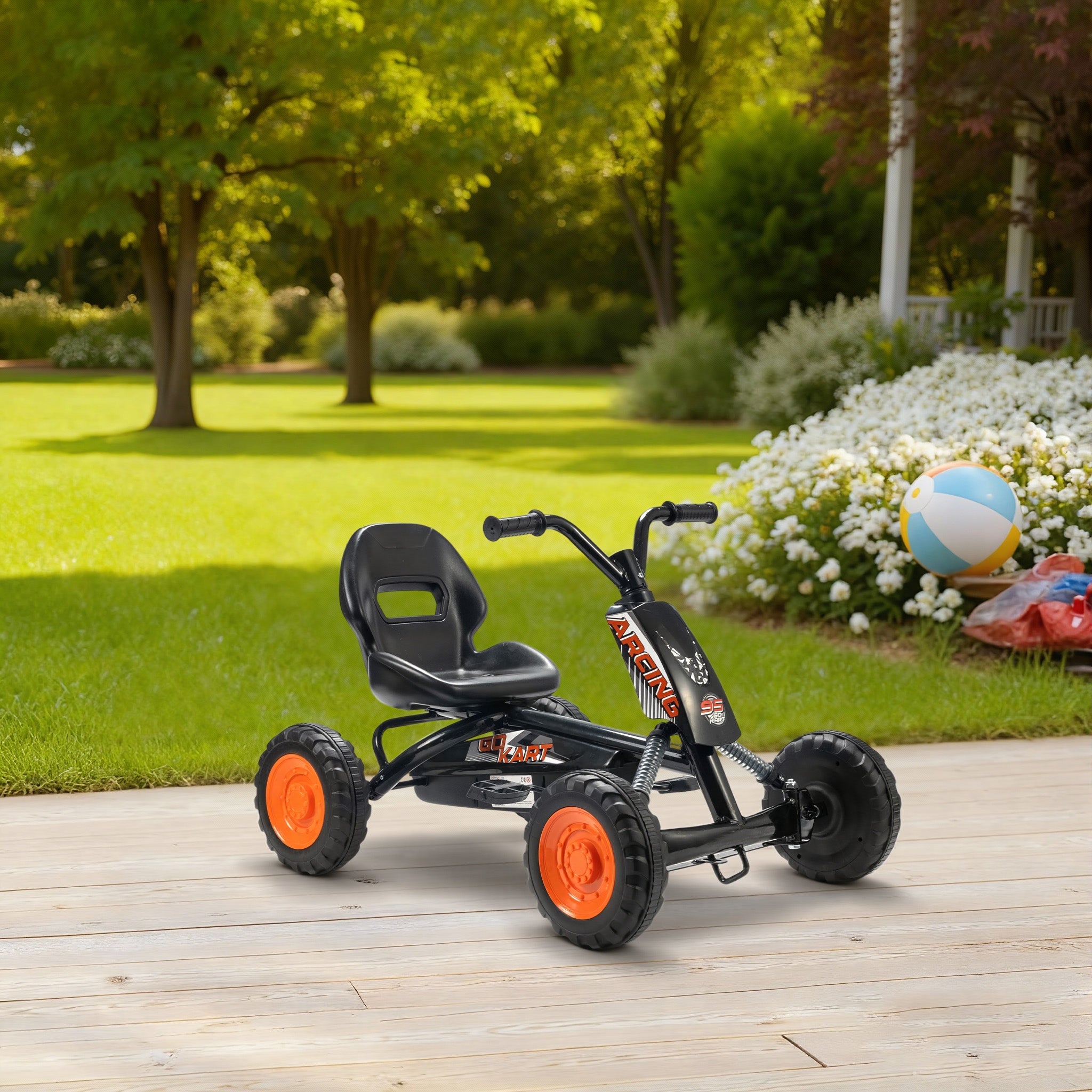 AIYAPLAY kids pedal go kart in black and orange with steel frame low-to-the-ground design and sporty racing lettering