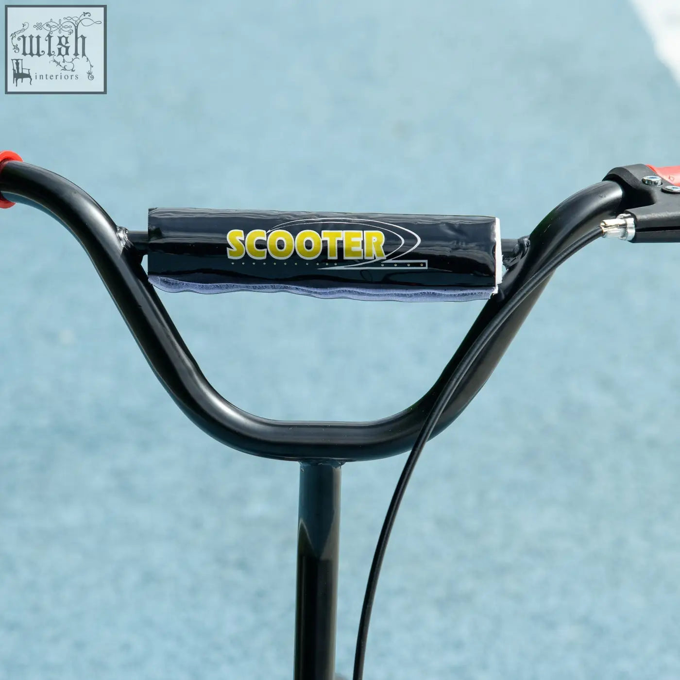 Black handlebar grip with yellow scooter branding on aiyaplay kids scooter featuring rear brake and non slip footplate