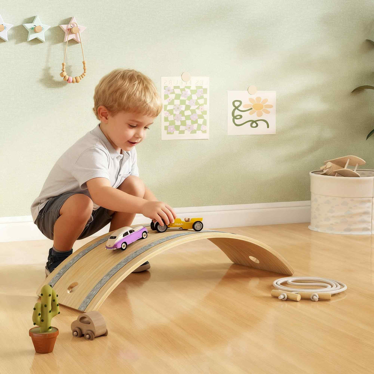 Light-colored wooden kids balance board with gray rubber strip for sensory play and balance training ages 3 to 6 years