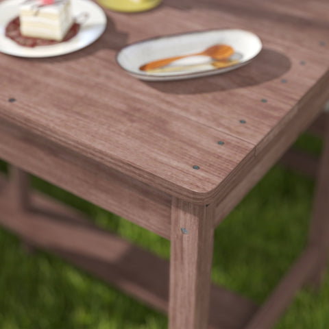 Rustic fir wood kids picnic table with visible screws and navy blue cushions perfect for four children outdoors
