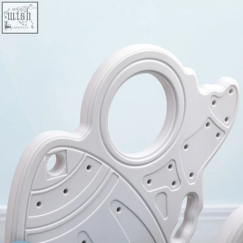 White plastic butterfly-shaped baby teething ring with textured surface for AIYAPLAY space themed kids slide buffer zone