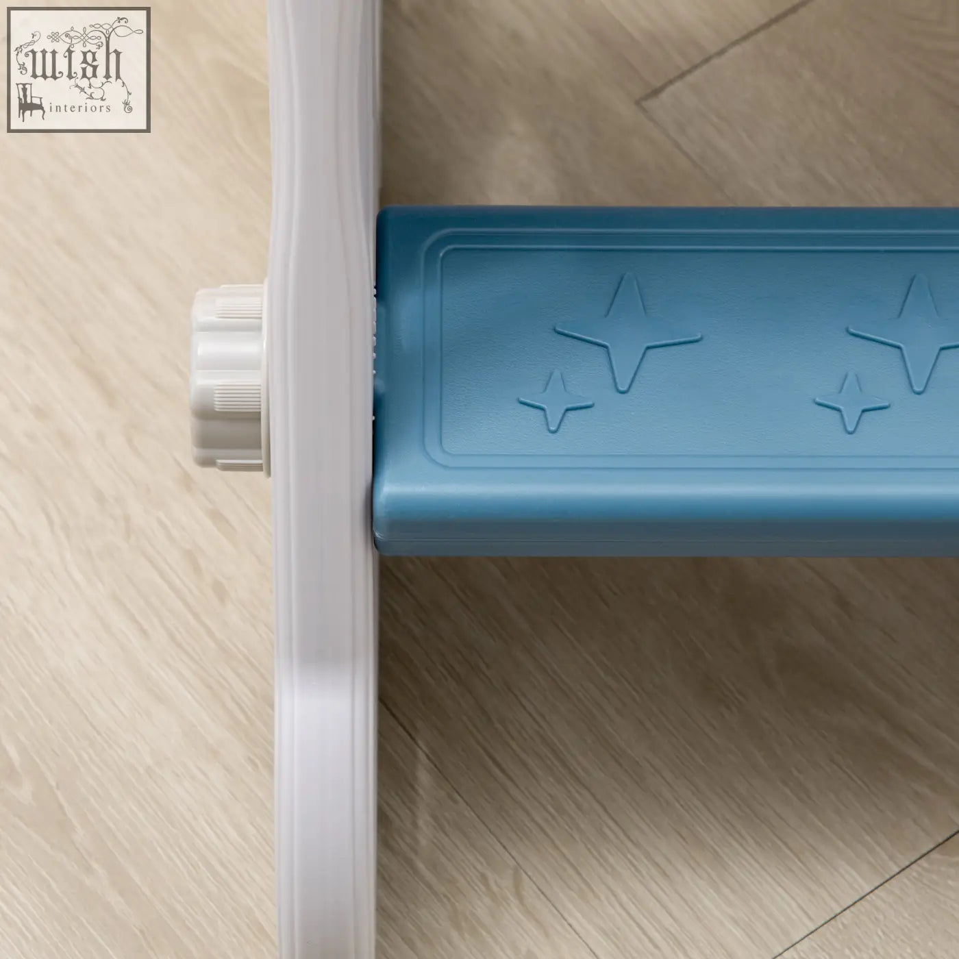 Blue plastic step with star-shaped embossments on a space themed kids slide buffer zone for toddlers
