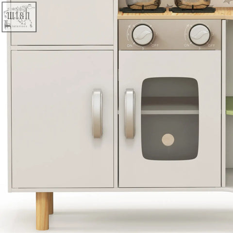 White wooden aiyaplay kids kitchen with silver handles, ice maker, stove, and faux oven door for kids play kitchen