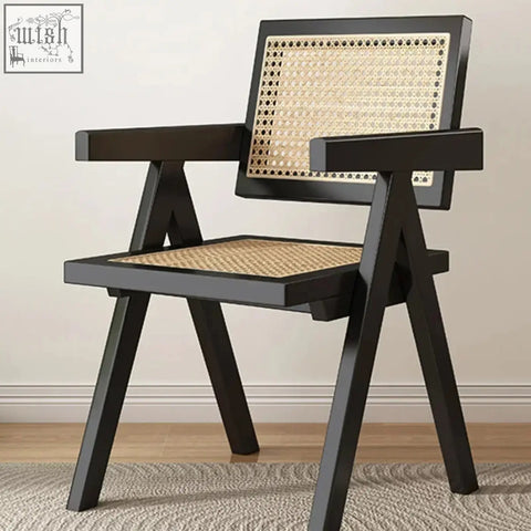 Black-framed Akane chair with woven rattan backrest and seat features a sleek silhouette perfect for any space