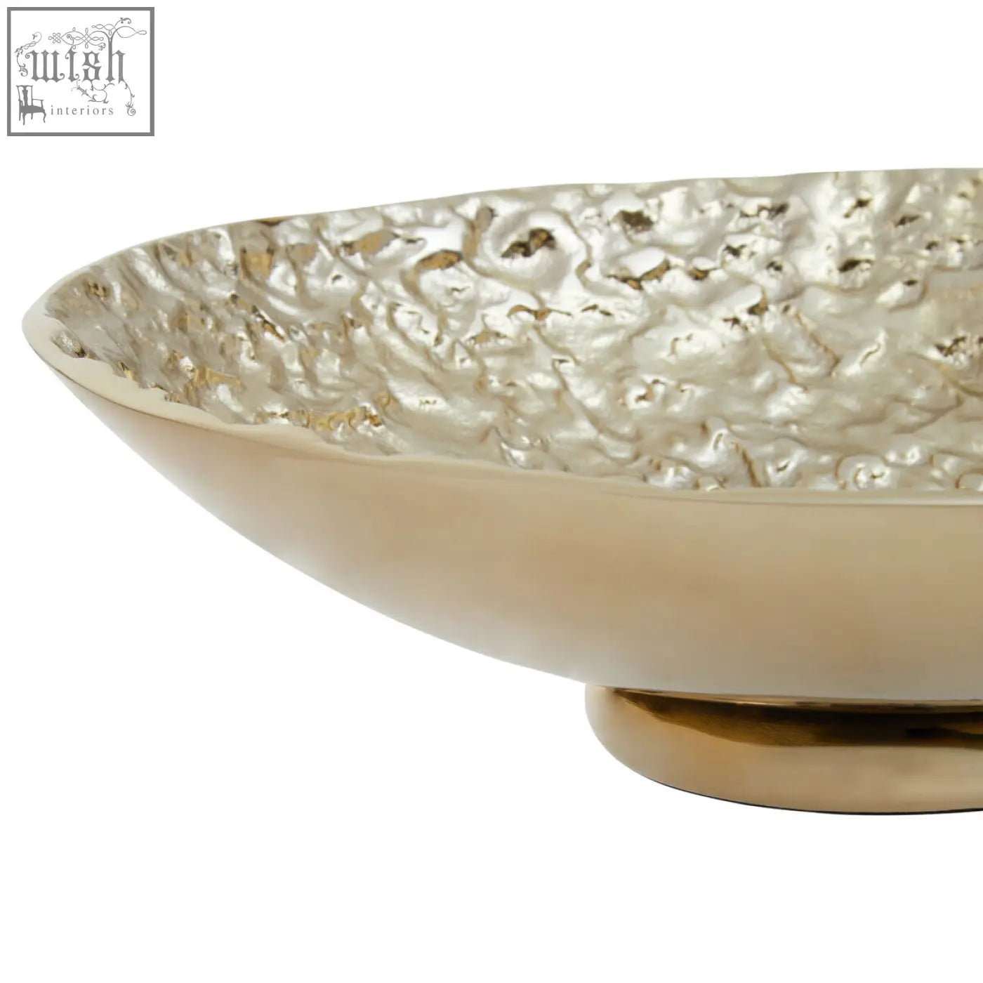 A gold textured round metal bowl with hammered interior and smooth exterior on a matching pedestal base