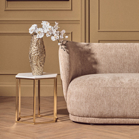Akola gold textured small metal vase holding white orchids with a shiny gold textured finish