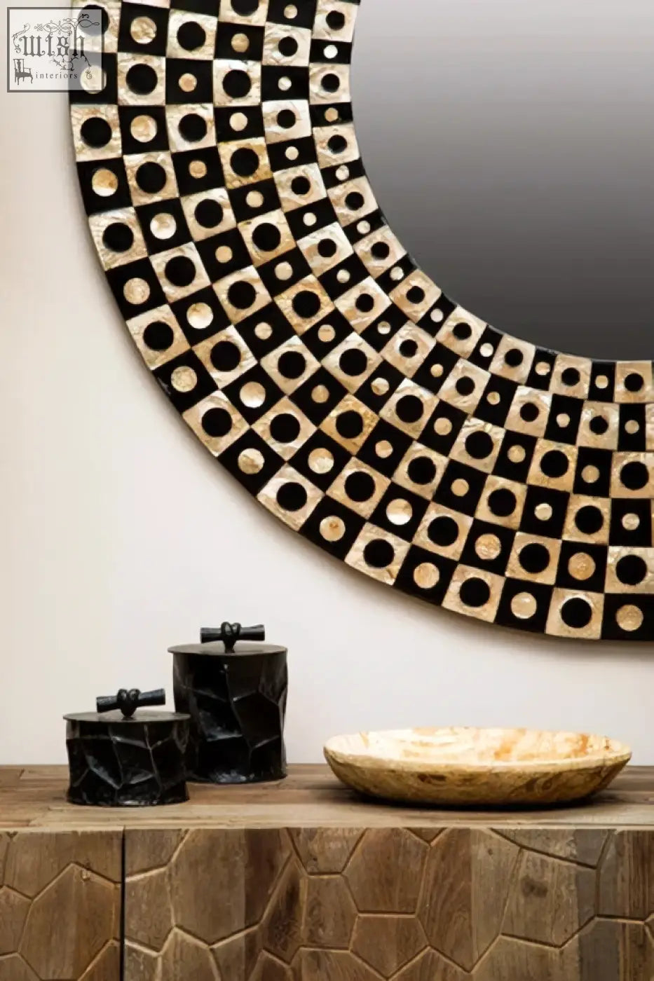 Circular mirror with black and cream geometric frame shown beside the akola large black and gold trinket box