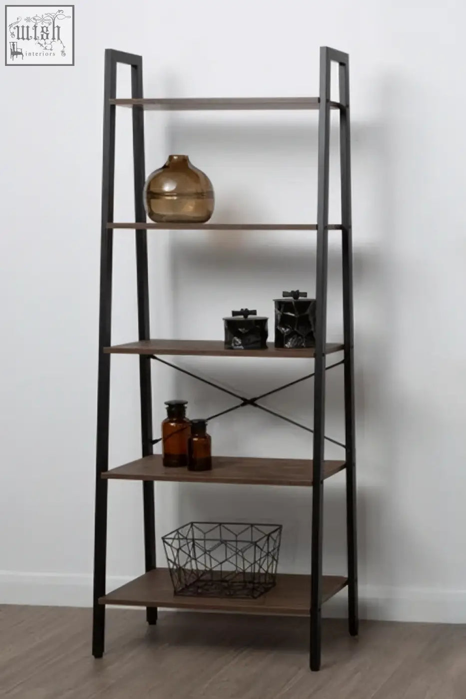Dark wood and black metal ladder shelf with diagonal cross braces showcasing a large black and gold trinket box