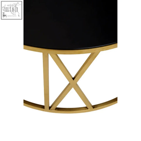 Alana round coffee table with a black glass top and gold metal x-shaped base perfect for living rooms