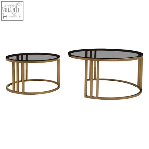 Gold-toned metal nesting coffee tables with black glass tops perfect for stylish living spaces