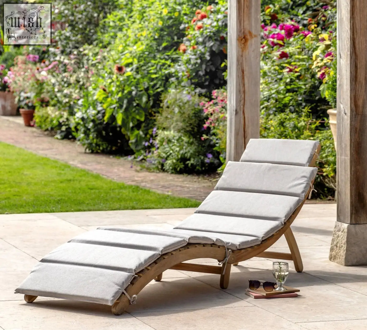 Light gray cushioned acacia wood alazzo foldable sunlounger with curved design and carry strap for easy transport