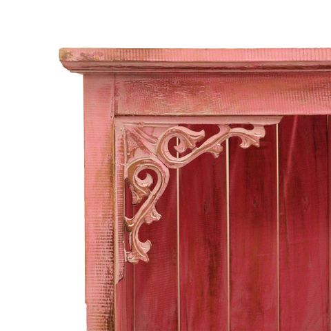 Distressed pinkwashed albasia bathroom cabinet corner with ornate carved metal floral bracket detail