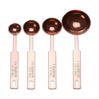 Set of five rose gold finish measuring spoons with engraved markings and loop handles in copper-toned metal