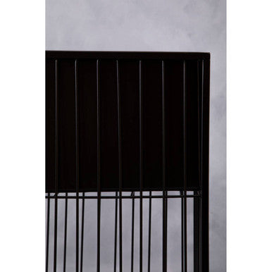 Black metal framed vertical slat headboard shown from back with alden floor standing planter in the background