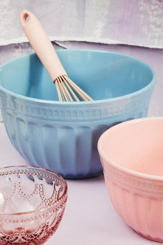 Blue ribbed ceramic mixing bowl with wooden handled whisk inside showcasing alden melamine extra large blue style