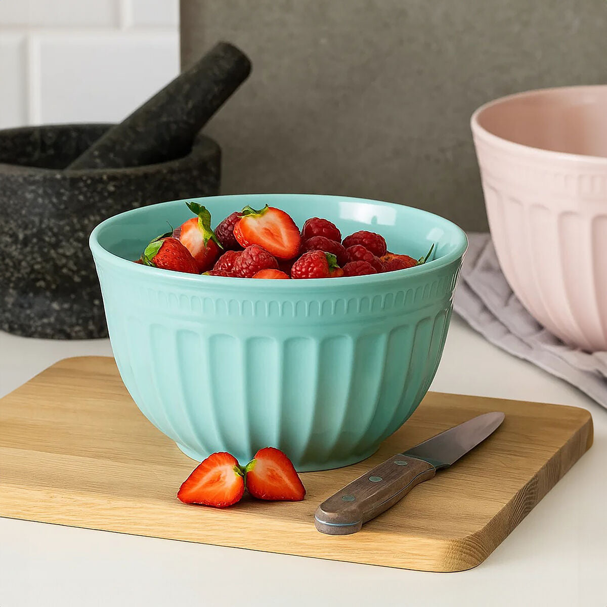 A teal ribbed alden melamine large mixing bowl filled with fresh strawberries and raspberries perfect for large green mixing
