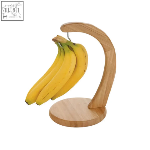 Light brown aleki bamboo banana hanger with curved arch and circular base for displaying bananas