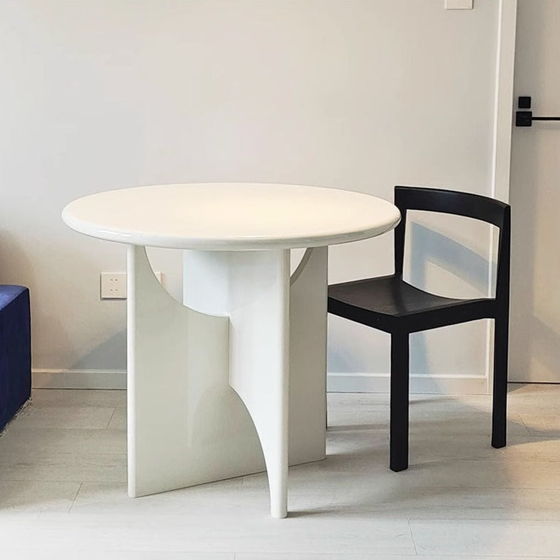 White round dining table with sculptural modern pedestal base perfect for stylish dining spaces