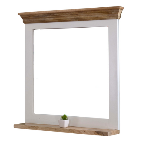 White-framed alfie mirror with natural mango wood crown and base plus small potted plant on shelf