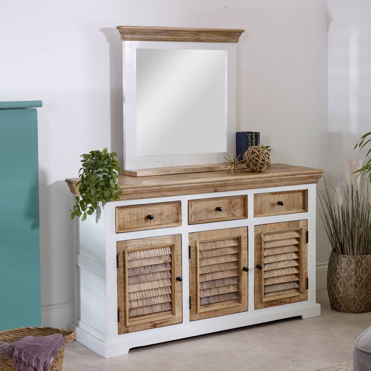 White and natural wood console table with louvered doors and alfie mango wood mirror frame with shelf above it